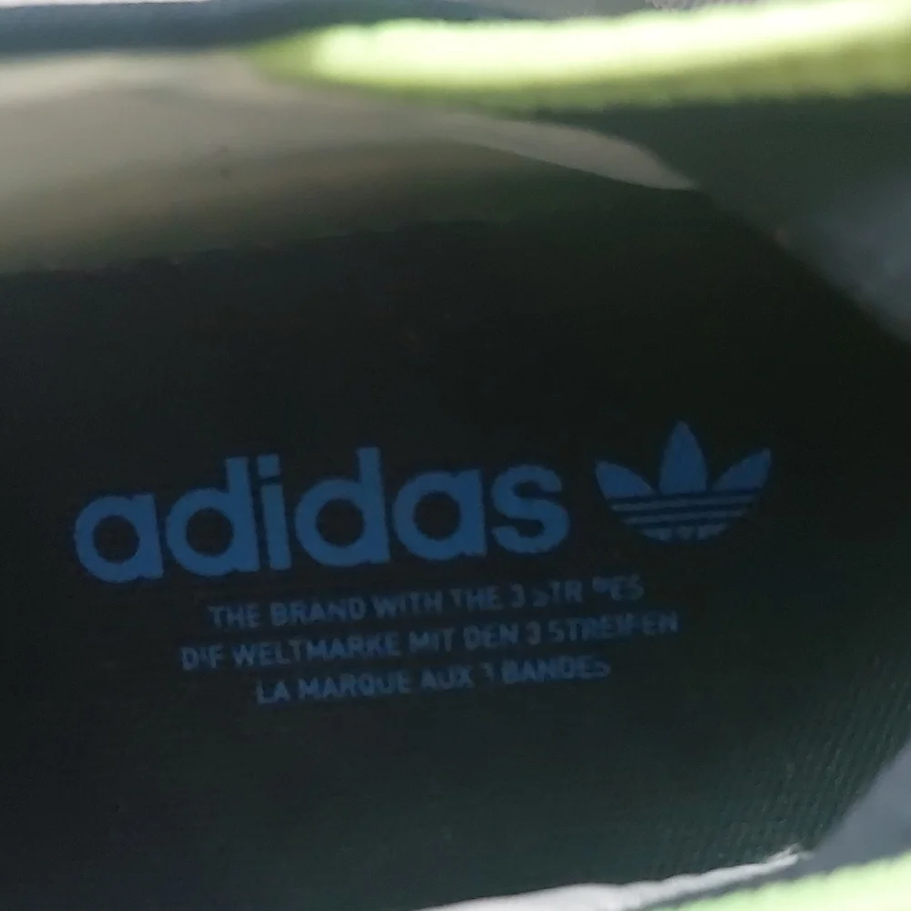 Adidas Adifom SLTN shoes in the Cloud White / SolarYellow / Blue Colorway